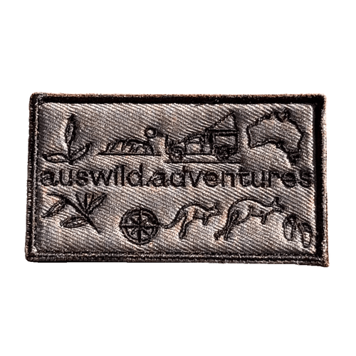 AWA Graphic embroidered travel patch featuring Aus Wild Adventures lettering surrounded by Uluru, a 4WD, kangaroos, compass, gum leaves and an Australia outline.
