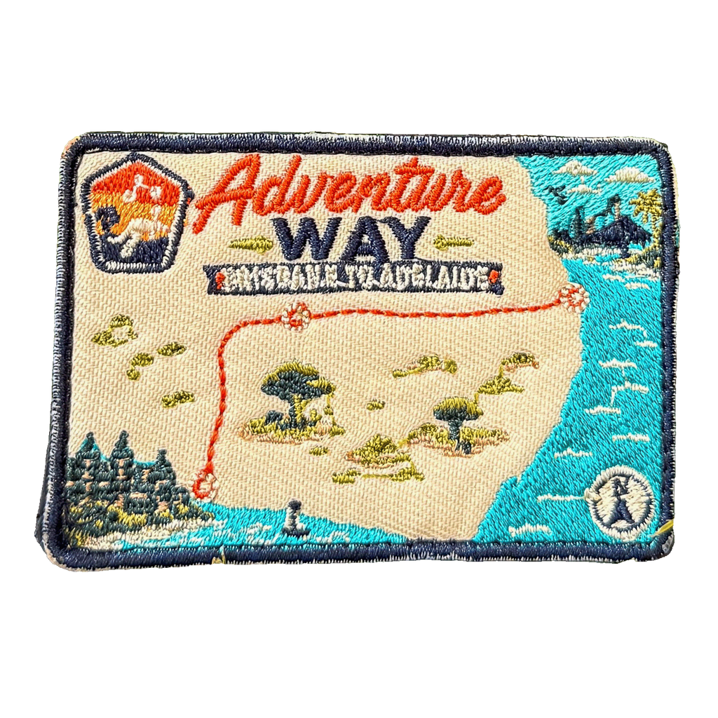 Adventure Way embroidered travel patch featuring map of the Brisbane to Adelaide route with dotted red road, coastal cities, outback trees and a compass.
