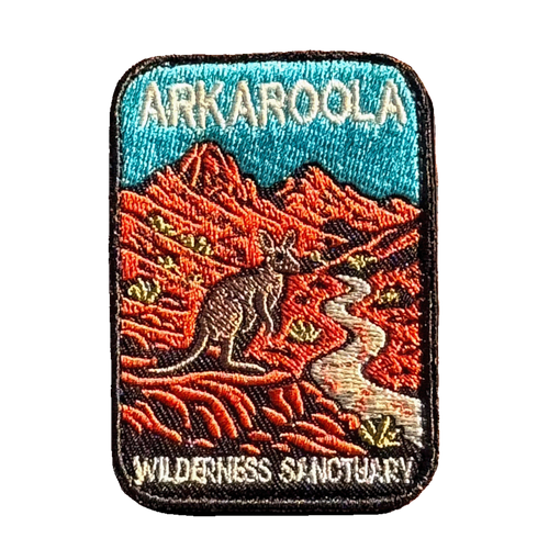 Arkaroola embroidered travel patch featuring kangaroo beside a winding track through rugged red mountains beneath a teal sky.