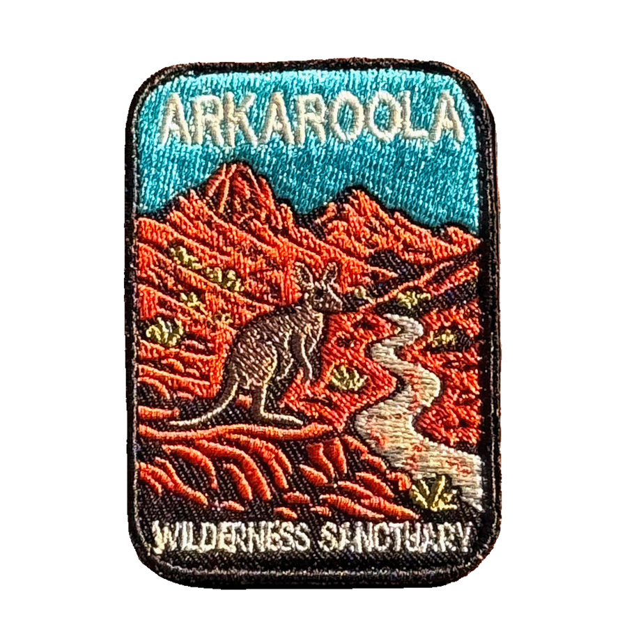 Arkaroola embroidered travel patch featuring kangaroo beside a winding track through rugged red mountains beneath a teal sky.
