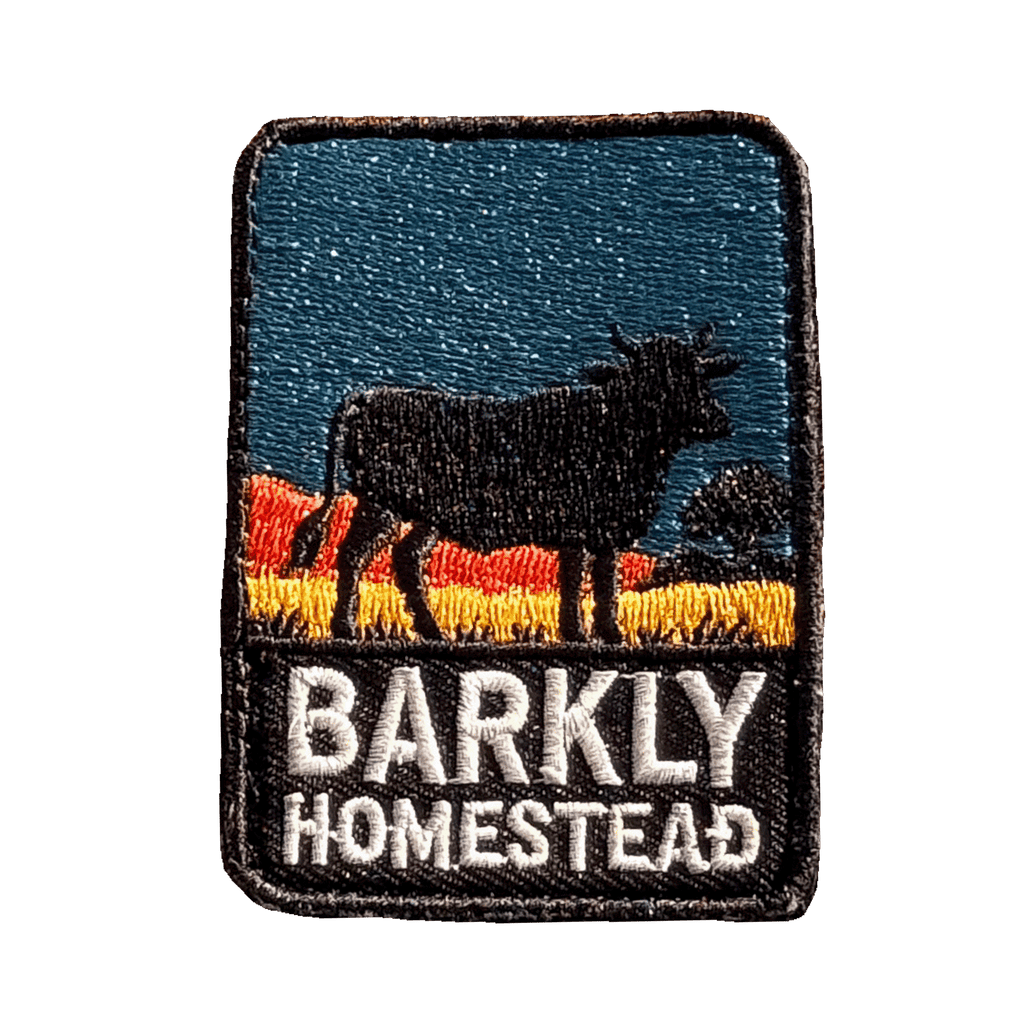 Barkly Homestead embroidered travel patch featuring dark cattle silhouette against orange outback hills and a teal sky.