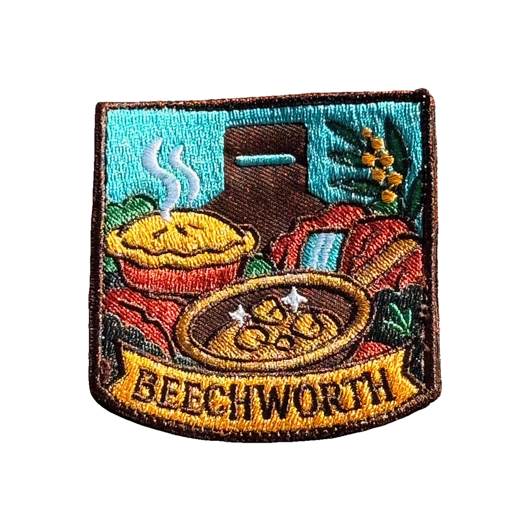 Beechworth embroidered travel patch featuring gold pan, steaming pie, historic chimney, waterfall and native wattle flowers.