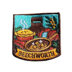 Beechworth embroidered travel patch featuring gold pan, steaming pie, historic chimney, waterfall and native wattle flowers.