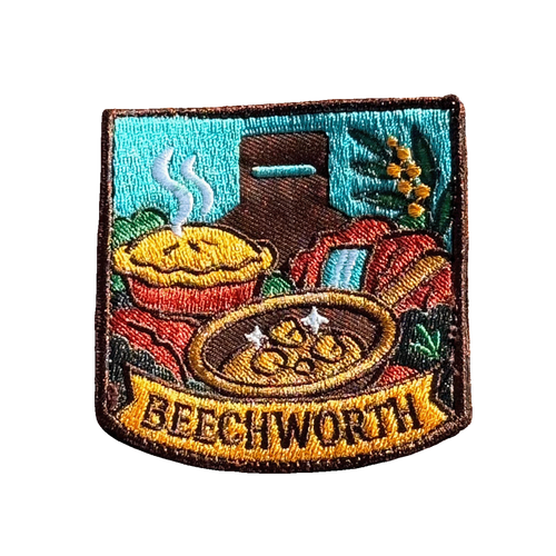 Beechworth embroidered travel patch featuring gold pan, steaming pie, historic chimney, waterfall and native wattle flowers.