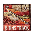 Binns Track embroidered travel patch featuring 4WD and dotted route crossing red desert country between the Northern Territory and South Australia.