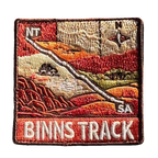 Binns Track embroidered travel patch featuring 4WD and dotted route crossing red desert country between the Northern Territory and South Australia.