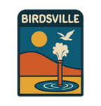 Birdsville illustrated travel patch design featuring artesian bore releasing water against orange desert dunes, a golden sun and a flying bird.