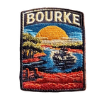 Bourke embroidered travel patch featuring paddle steamer cruising along a winding river through red outback scenery at sunset.