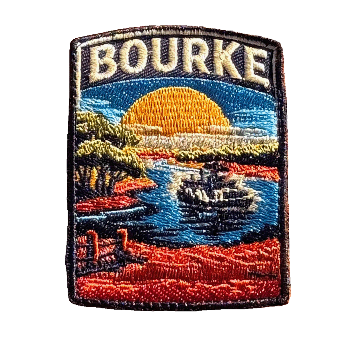 Bourke embroidered travel patch featuring paddle steamer cruising along a winding river through red outback scenery at sunset.