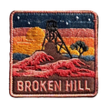 Broken Hill embroidered travel patch featuring historic mining headframe silhouetted against an orange sunset and red rocky outback.