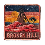 Broken Hill embroidered travel patch featuring historic mining headframe silhouetted against an orange sunset and red rocky outback.