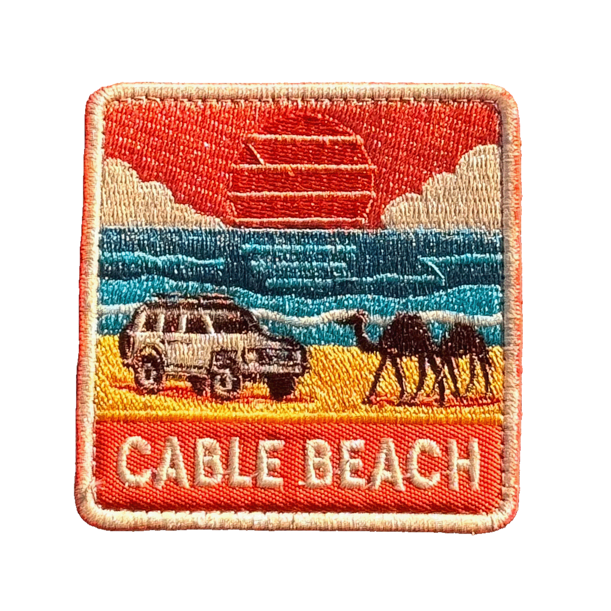 Broome - Cable Beach embroidered travel patch featuring 4WD and two camels on golden sand beside turquoise ocean at sunset.