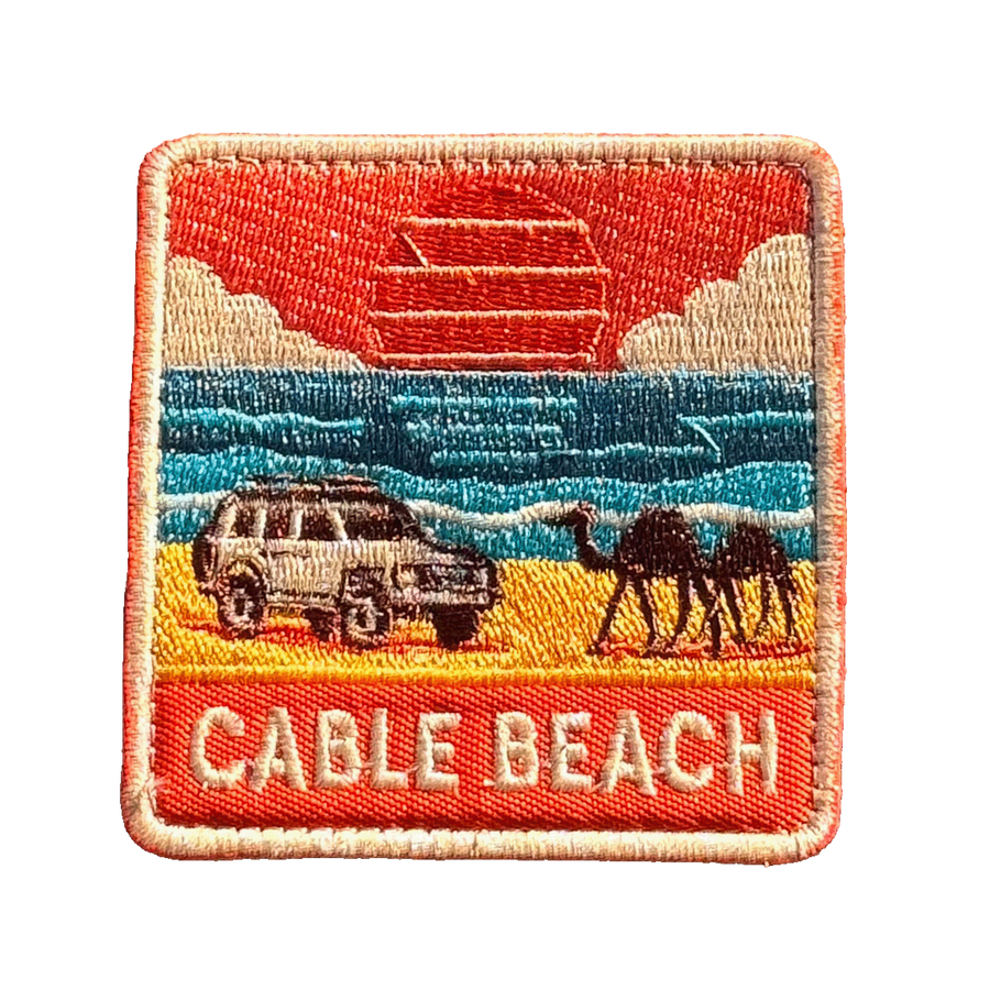 Broome - Cable Beach embroidered travel patch featuring 4WD and two camels on golden sand beside turquoise ocean at sunset.