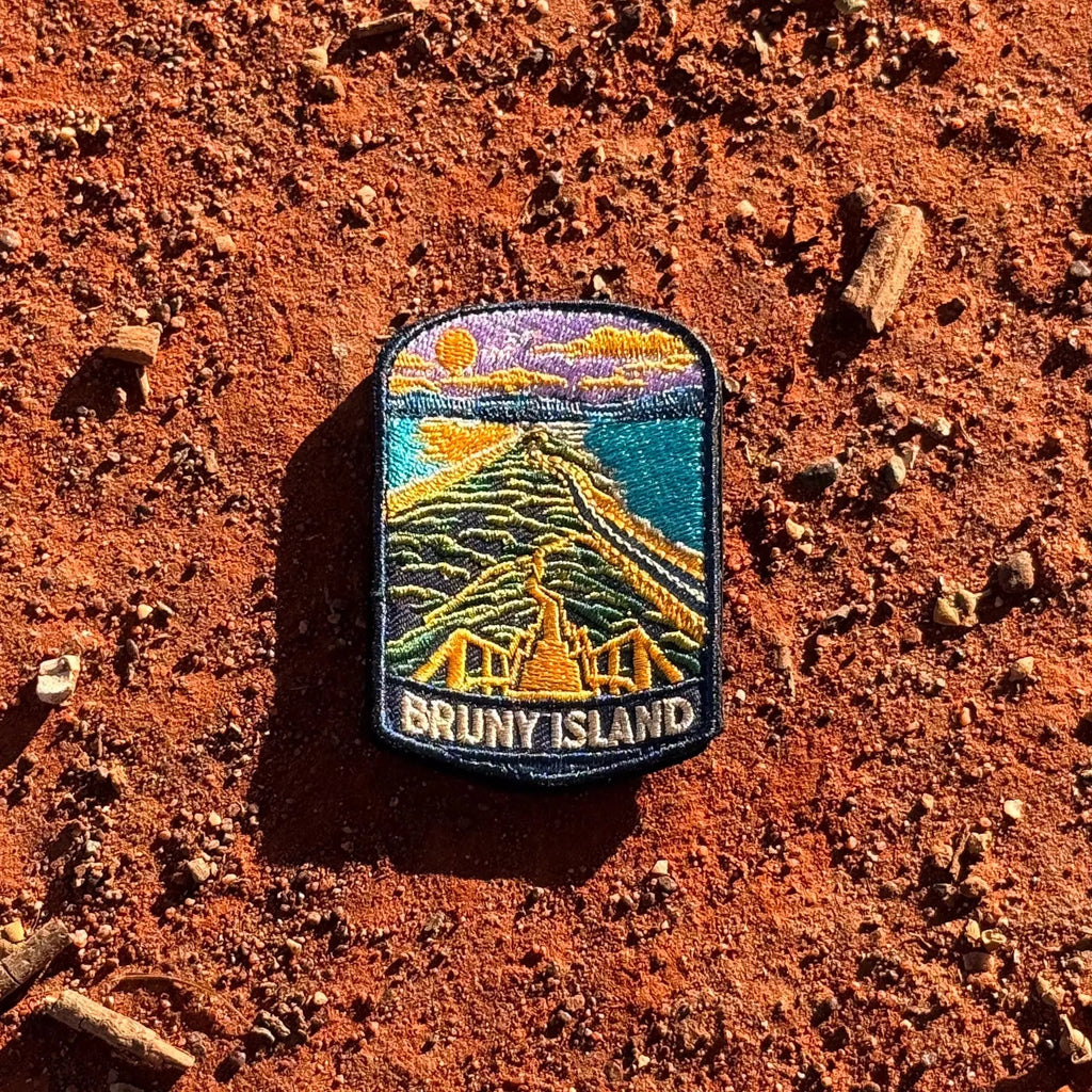 Bruny Island embroidered travel patch with a white lighthouse overlooking a rugged island coast.