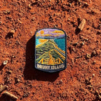 Bruny Island embroidered travel patch with a white lighthouse overlooking a rugged island coast.