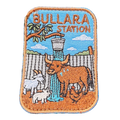 Bullara Station embroidered travel patch with a windmill and rustic outback station scenery; photographed on a transparent background.