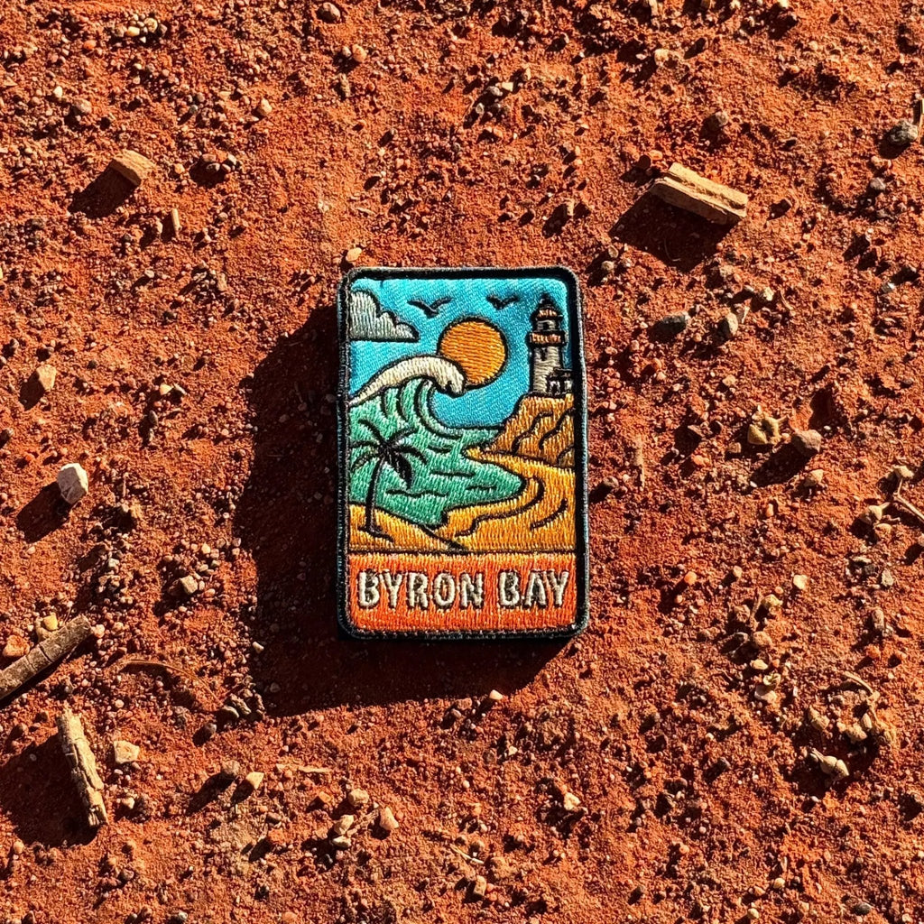 Byron Bay embroidered travel patch with Cape Byron Lighthouse above the coast.