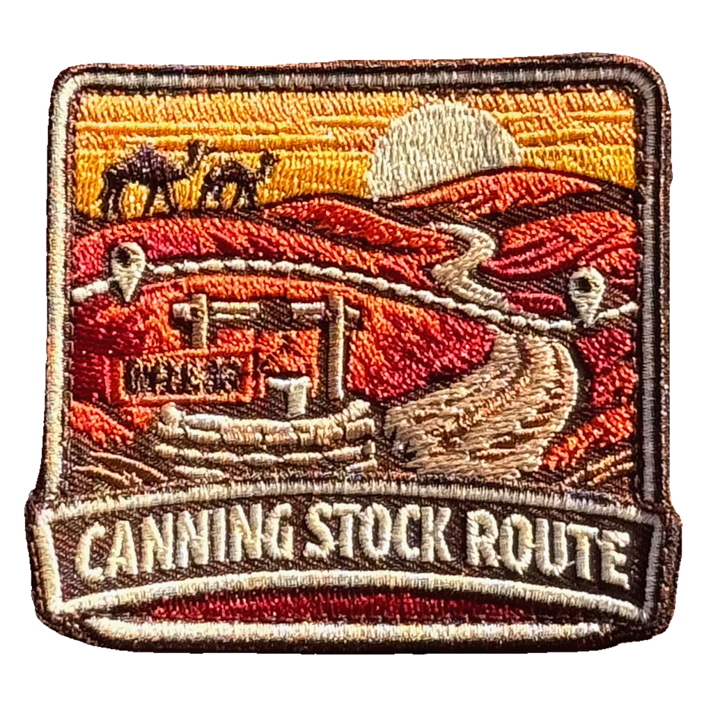 Canning Stock Route embroidered travel patch with a four-wheel drive on a remote outback track; photographed on a transparent background.