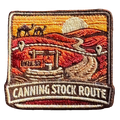 Canning Stock Route embroidered travel patch with a four-wheel drive on a remote outback track; photographed on a transparent background.