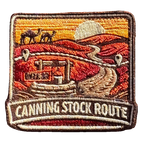 Canning Stock Route embroidered travel patch with a four-wheel drive on a remote outback track; photographed on a transparent background.