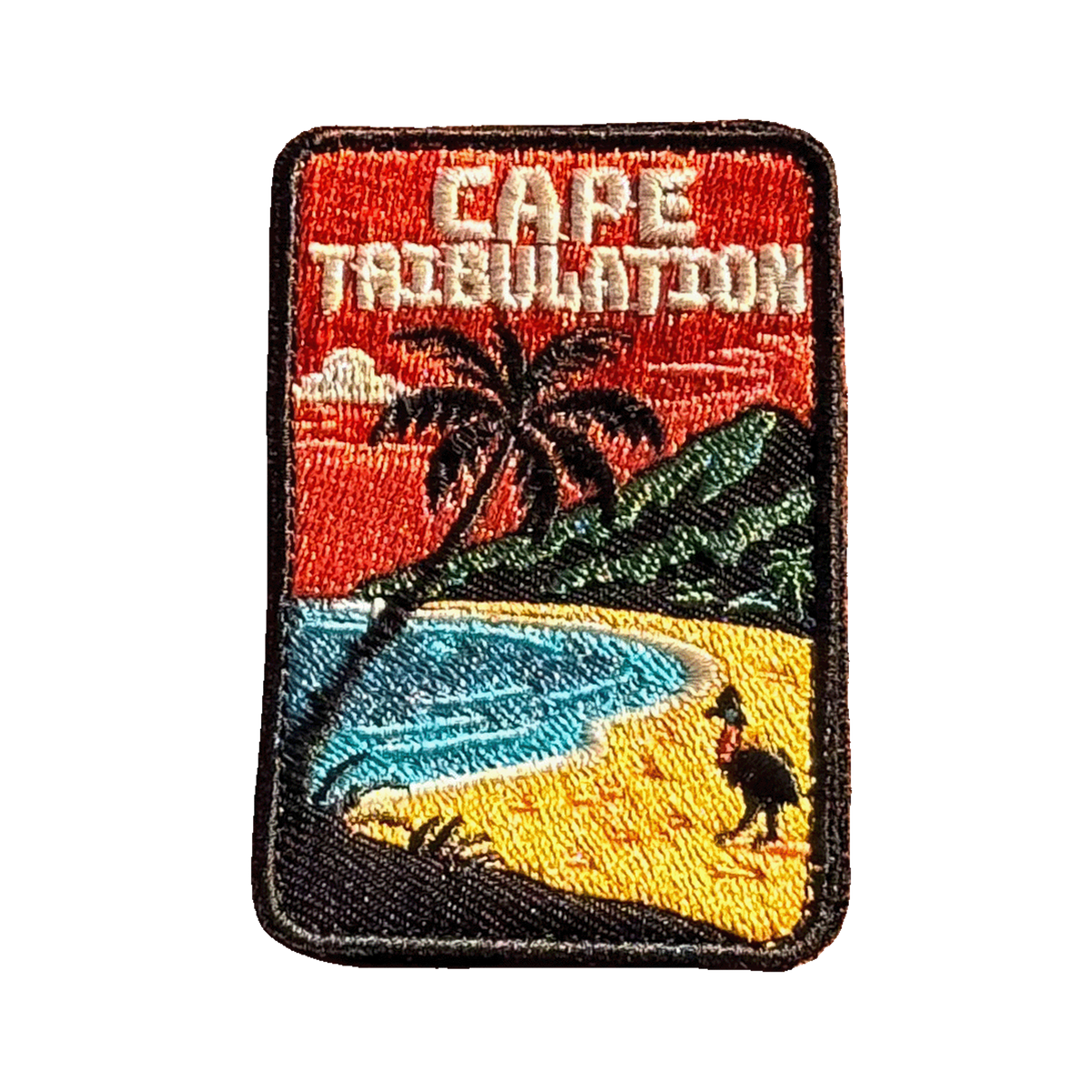 Cape Tribulation embroidered travel patch with rainforest meeting a tropical beach; photographed on a transparent background.