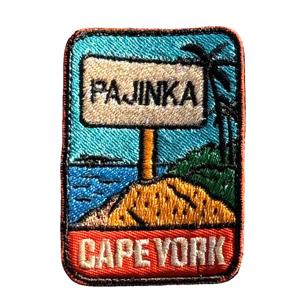 Cape York - The Tip embroidered travel patch with the Tip of Australia sign in a tropical coastal setting; photographed on a transparent background.