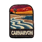 Carnarvon embroidered travel patch with a coastal jetty and palm trees; photographed on a transparent background.