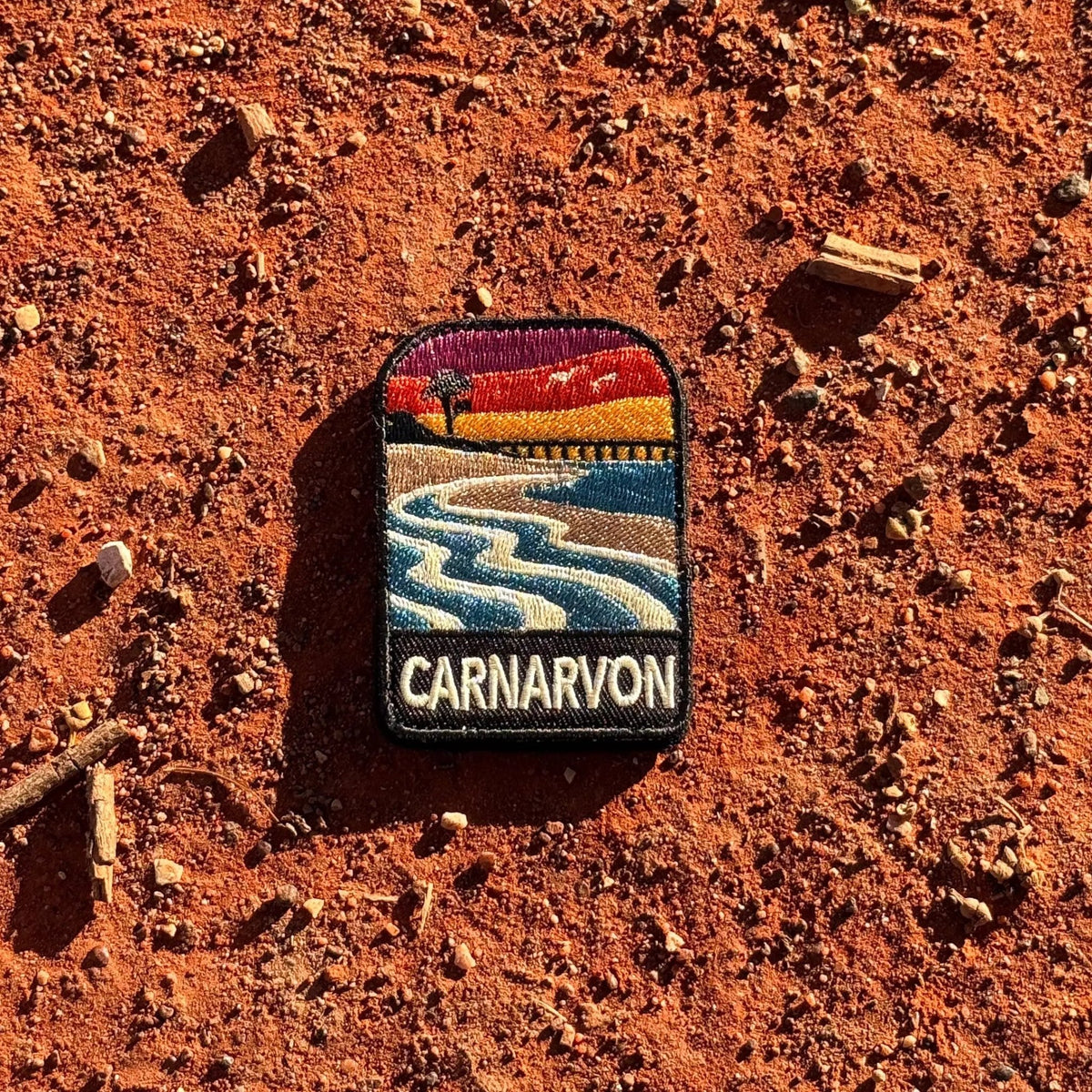 Carnarvon embroidered travel patch with a coastal jetty and palm trees.