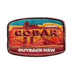 Cobar embroidered travel patch with a mining headframe in a red outback landscape; photographed on a transparent background.