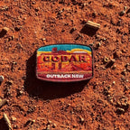 Cobar embroidered travel patch with a mining headframe in a red outback landscape.