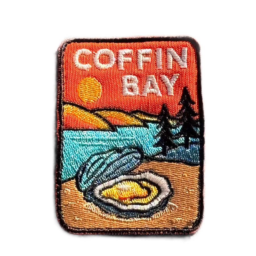 Coffin Bay embroidered travel patch with a white sandy beach and turquoise coastline; photographed on a transparent background.