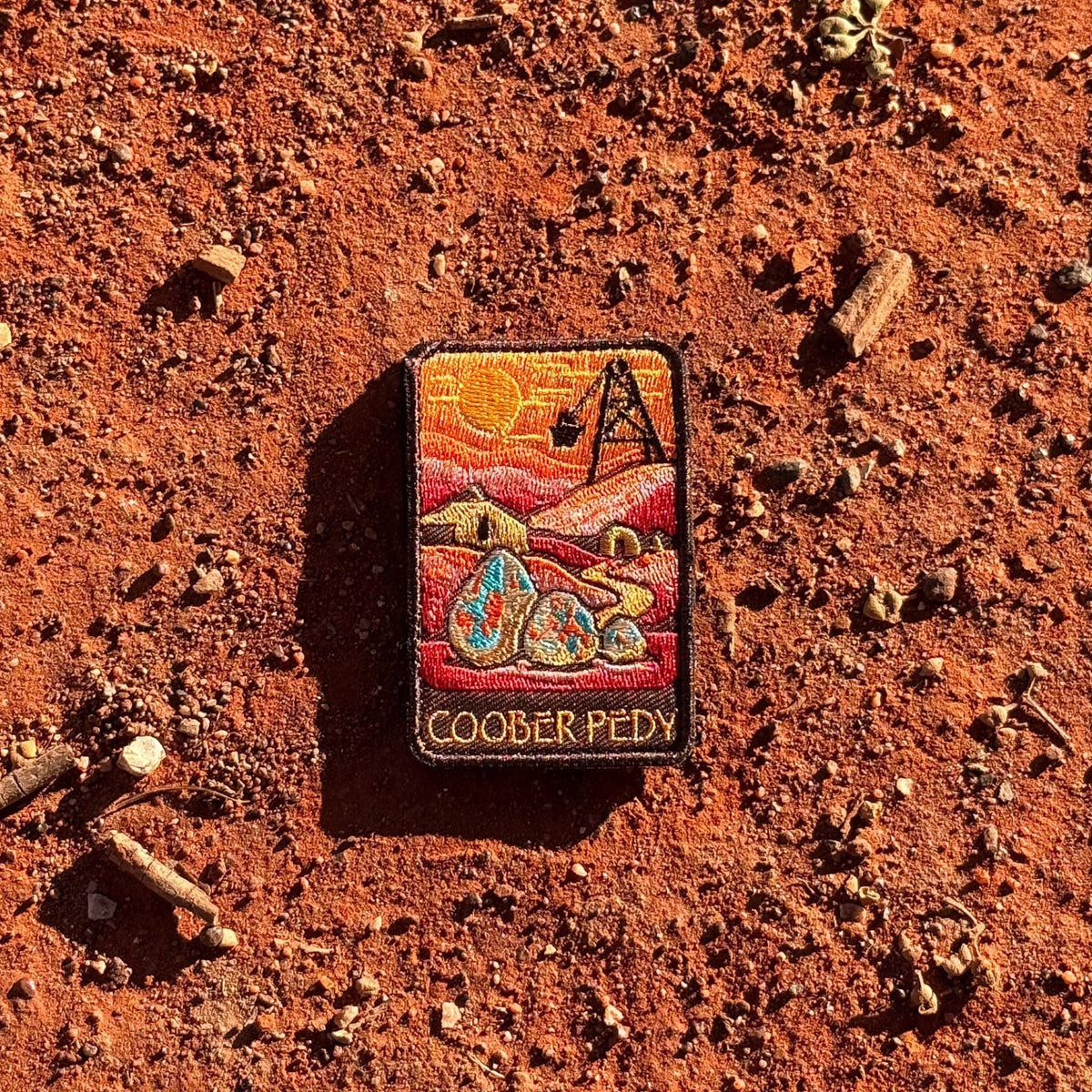 Coober Pedy embroidered travel patch with an opal-mining and underground dugout landscape.