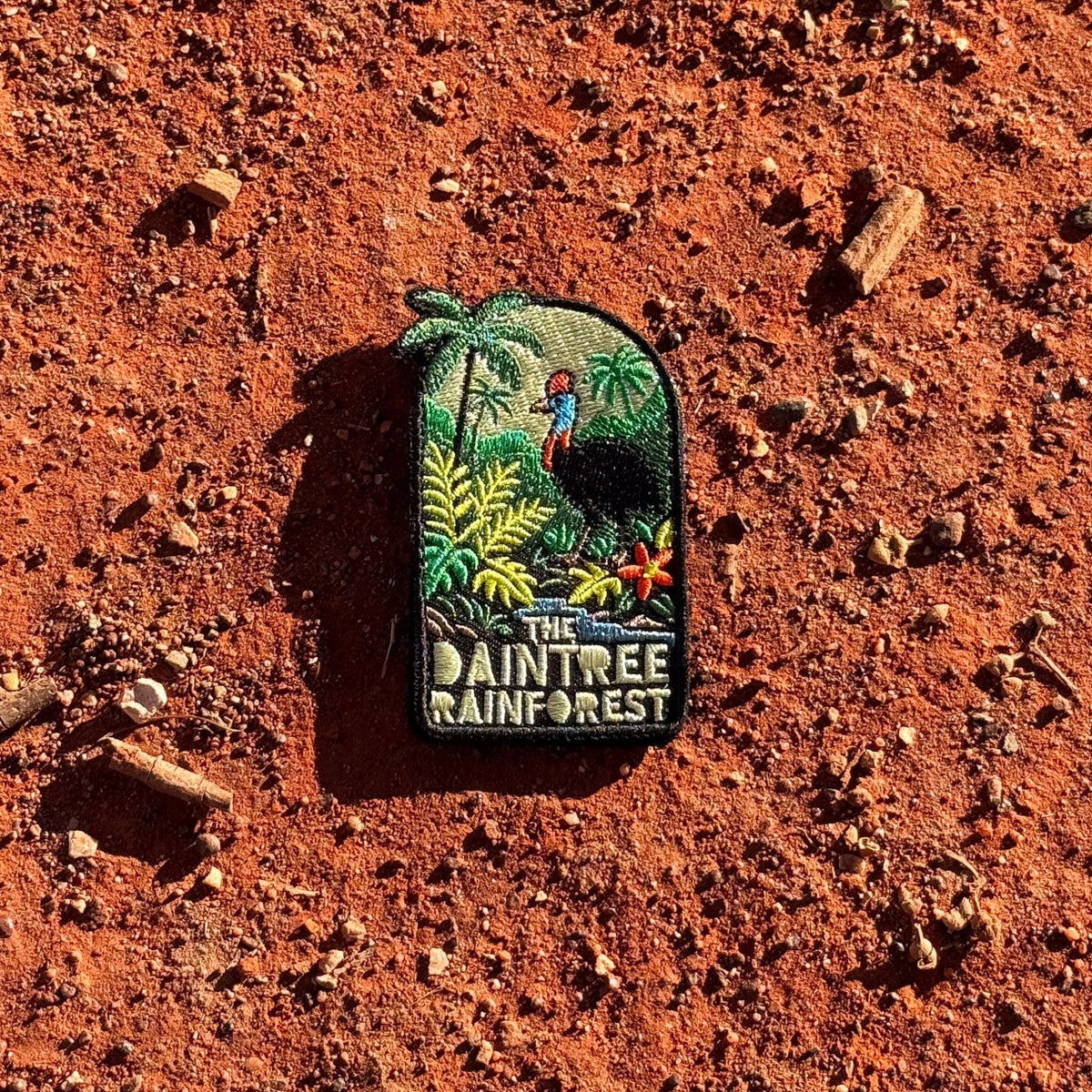 Daintree Rainforest embroidered travel patch with a cassowary surrounded by tropical rainforest, palms and flowers.