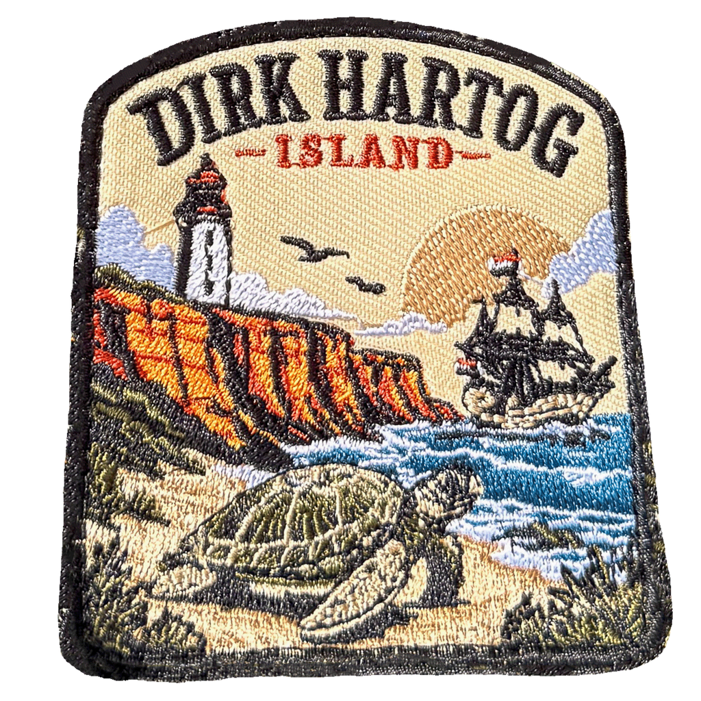 Dirk Hartog Island embroidered travel patch with a lighthouse on a rugged island coast; photographed on a transparent background.