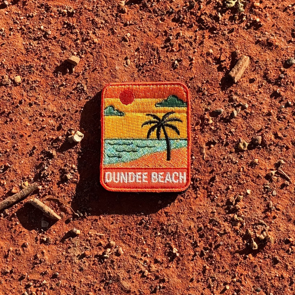 Dundee Beach embroidered travel patch with a tropical beach with palm trees.