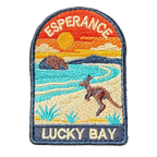 Esperance - Lucky Bay embroidered travel patch with a kangaroo on the white sand of Lucky Bay beside turquoise water; photographed on a transparent background.