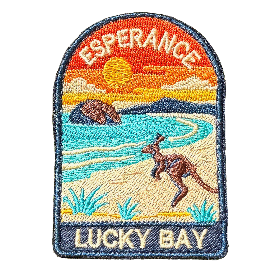 Esperance - Lucky Bay embroidered travel patch with a kangaroo on the white sand of Lucky Bay beside turquoise water; photographed on a transparent background.