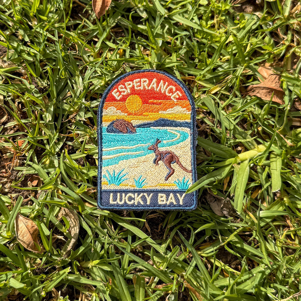 Esperance - Lucky Bay embroidered travel patch with a kangaroo on the white sand of Lucky Bay beside turquoise water.