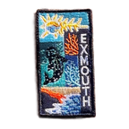 Exmouth embroidered travel patch with a whale shark swimming through blue ocean; photographed on a transparent background.