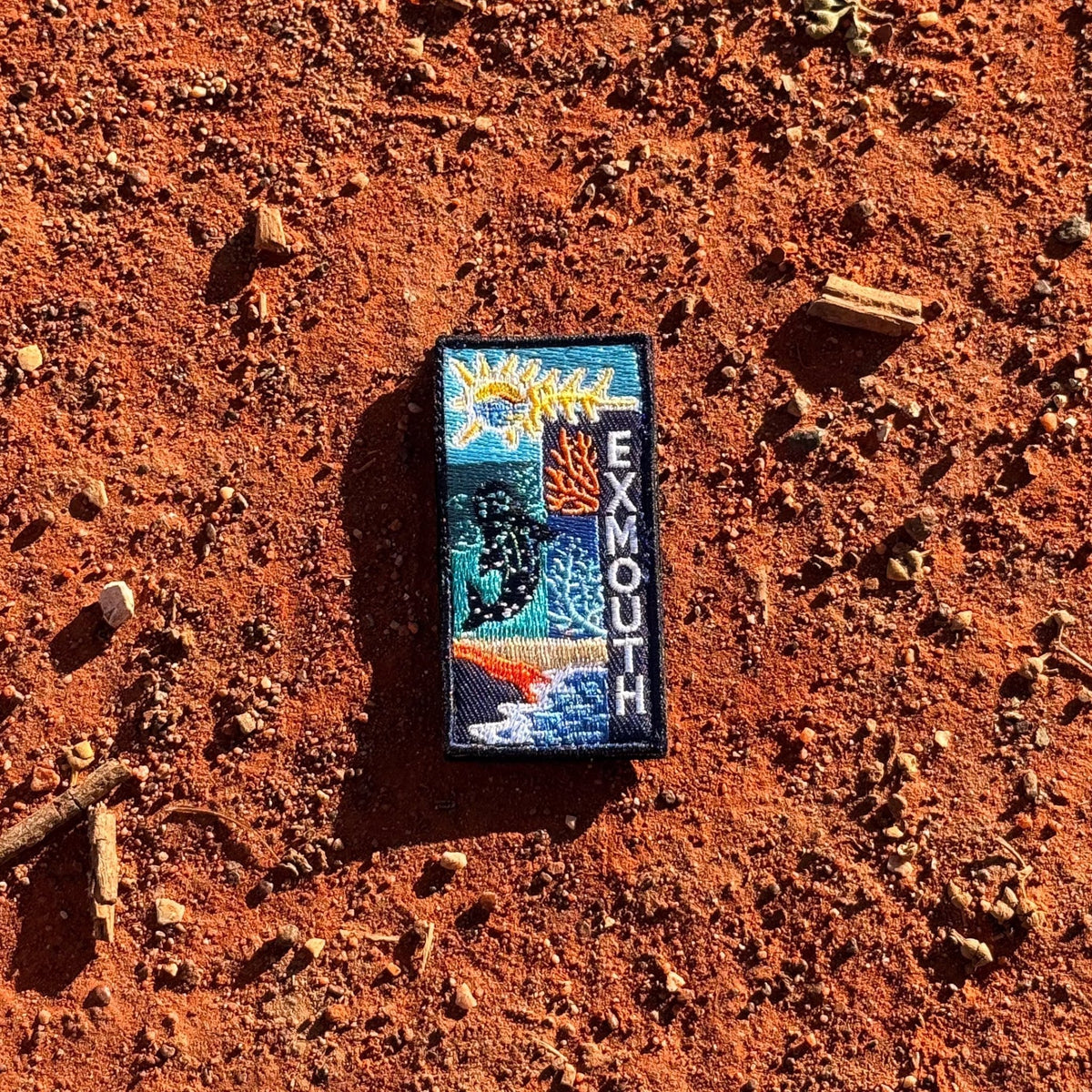 Exmouth embroidered travel patch with a whale shark swimming through blue ocean.