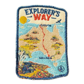 Explorers Way embroidered travel patch with an outback road through red desert country; photographed on a transparent background.
