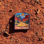 Finke Gorge embroidered travel patch with red gorge walls and desert vegetation.