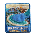 Freycinet - Wineglass Bay embroidered travel patch with Wineglass Bay, turquoise water and granite mountains; photographed on a transparent background.