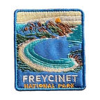 Freycinet - Wineglass Bay embroidered travel patch with Wineglass Bay, turquoise water and granite mountains; photographed on a transparent background.