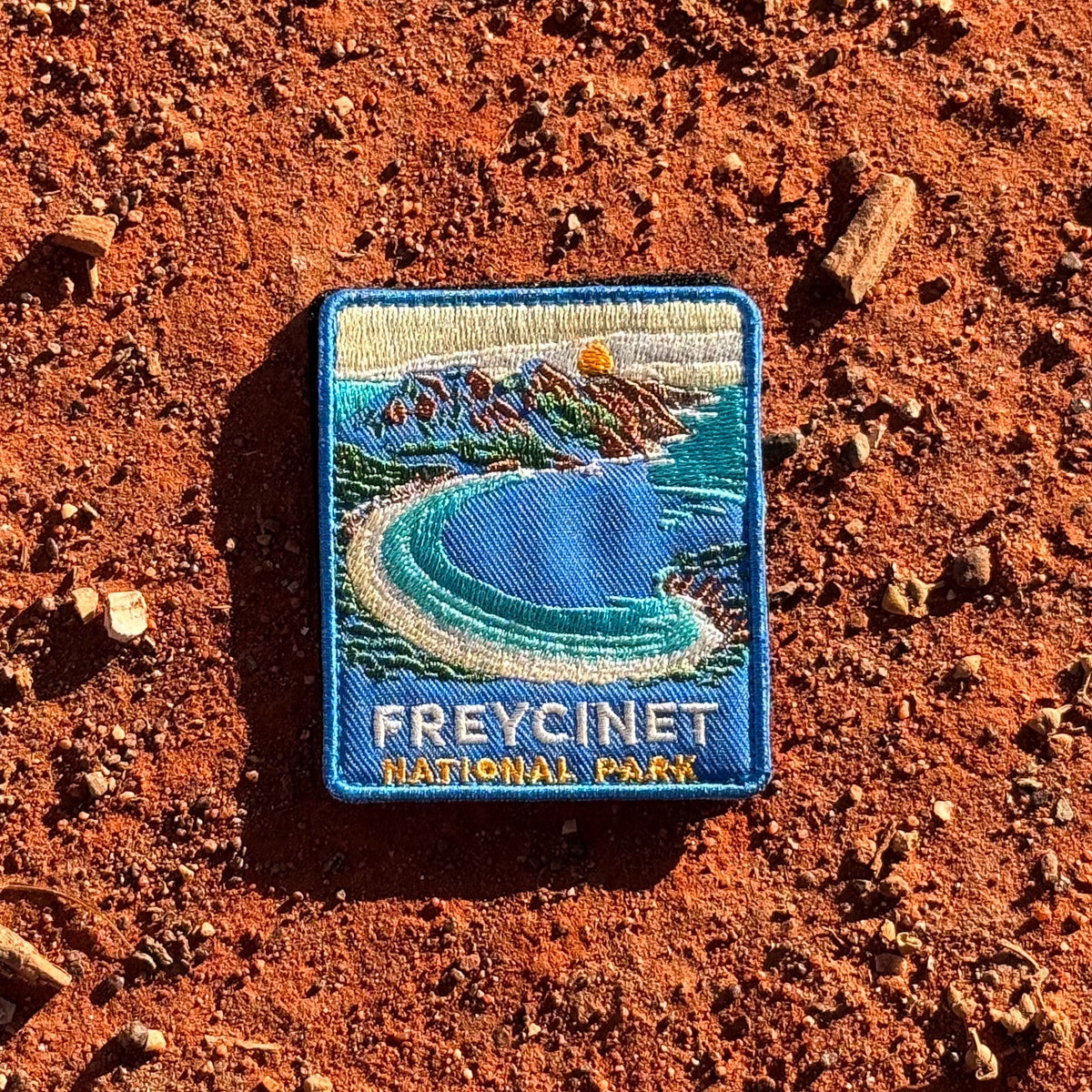 Freycinet - Wineglass Bay embroidered travel patch with Wineglass Bay, turquoise water and granite mountains.