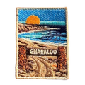 Gnaraloo Station embroidered travel patch with a breaking ocean wave along a rugged coastline; photographed on a transparent background.
