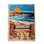 Gnaraloo Station embroidered travel patch with a breaking ocean wave along a rugged coastline; photographed on a transparent background.