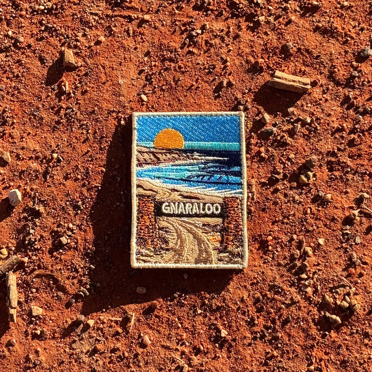 Gnaraloo Station embroidered travel patch with a breaking ocean wave along a rugged coastline.