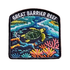 Great Barrier Reef embroidered travel patch with a sea turtle above a colourful coral reef; photographed on a transparent background.