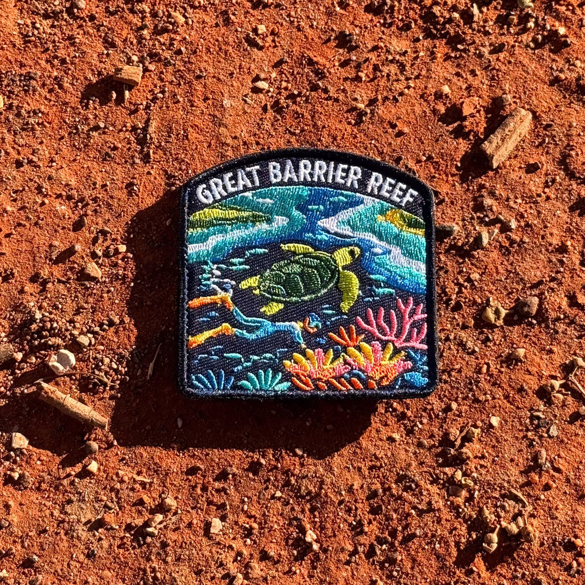 Great Barrier Reef embroidered travel patch with a sea turtle above a colourful coral reef.